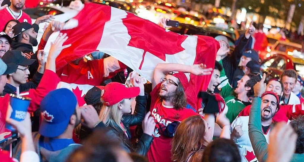 people with a flag on Canadian hockey